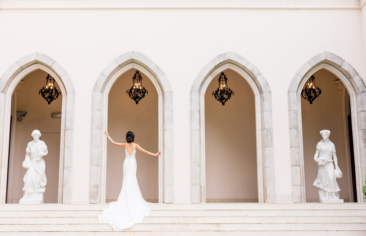 Light and Airy Bride poses in her wedding dress