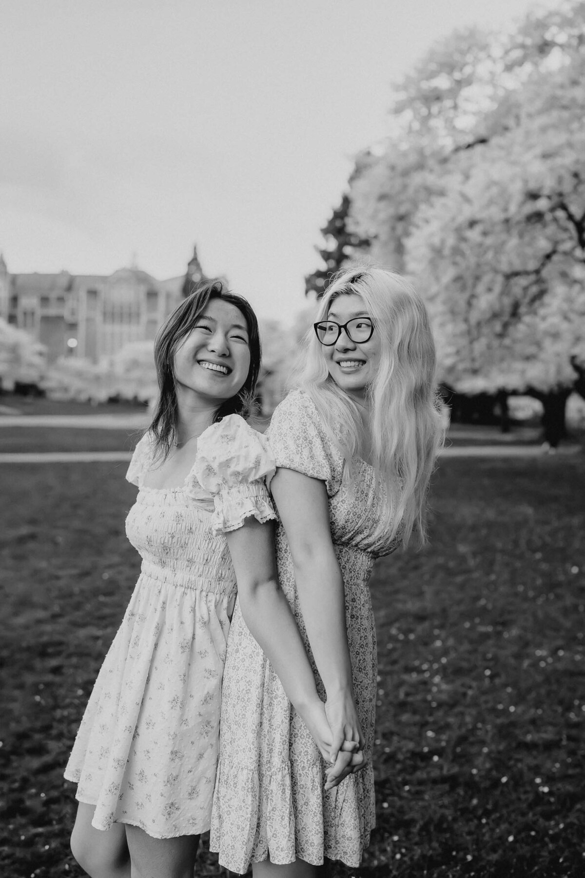 Sweet black and white photo of siblings sharing a quiet, affectionate moment on the University of Washington campus.
