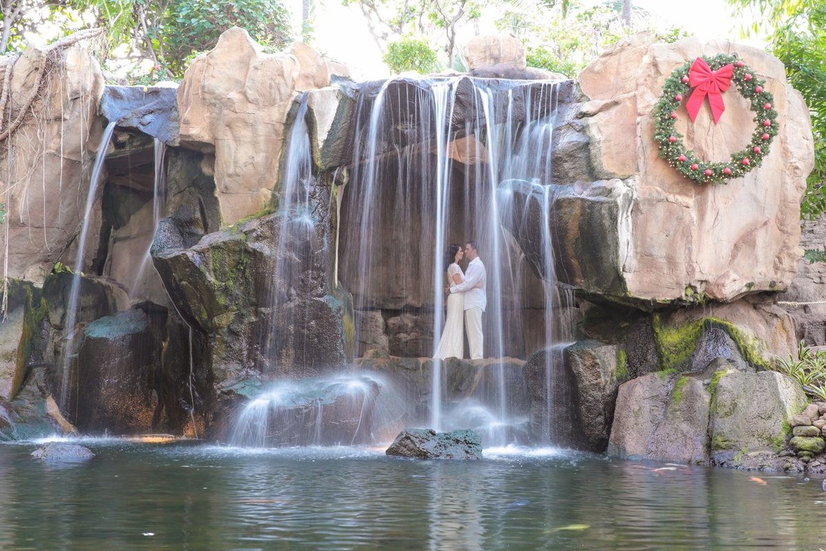 Wedding Photography at The Westin Maui Resort and Spa with bride and groom in the lobby in front of the waterfall