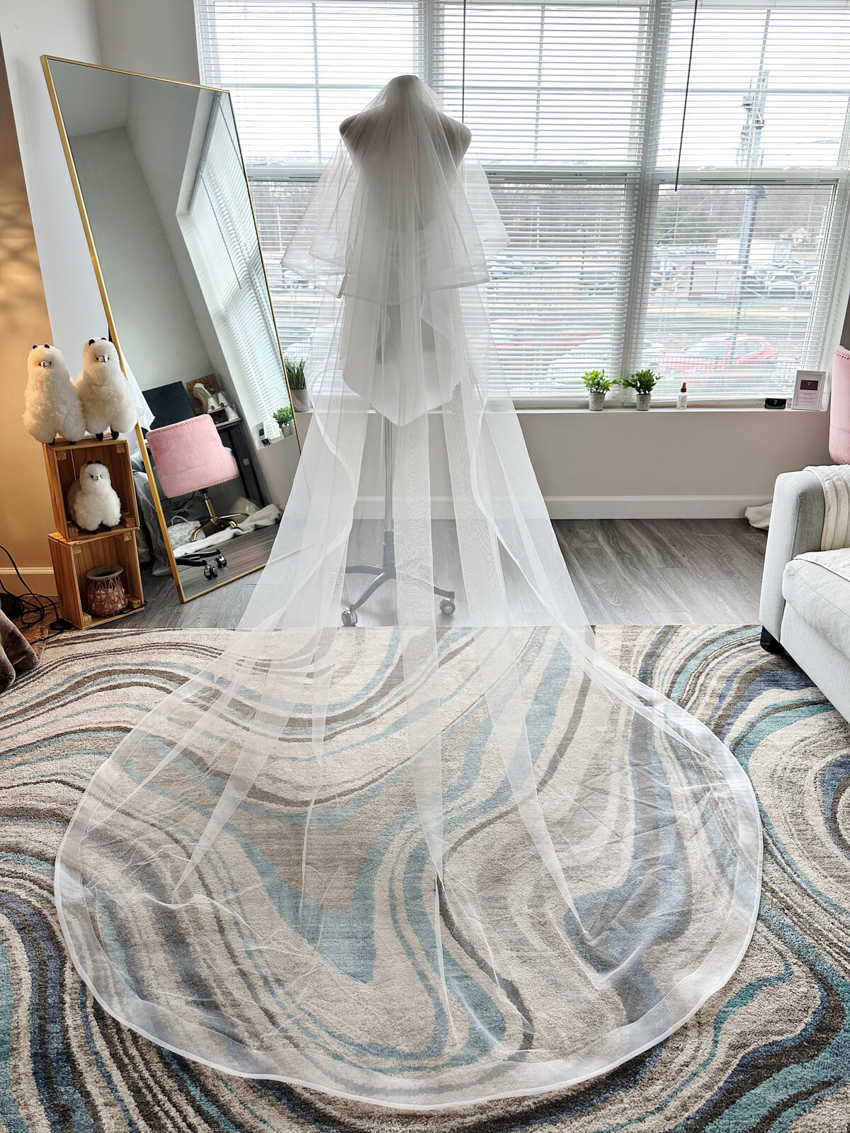 Bride gently lifting lace blusher veil before first kiss
