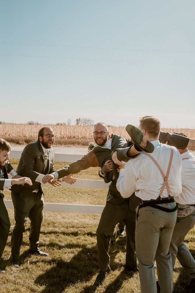 storyteller-collective-photo-co-groomsmen-laughing-candid-iowa