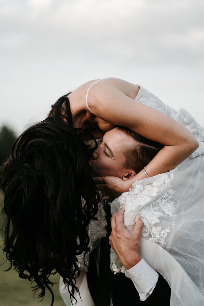 Bride kissing groom planned by luxury wedding planner chicago