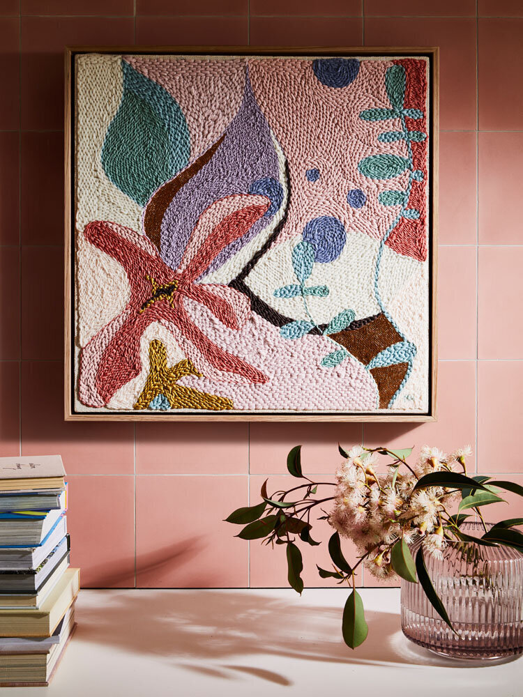 Colourful floral art on pink tiles with native florals and terrazzo table, styled by Melbourne interior stylist.