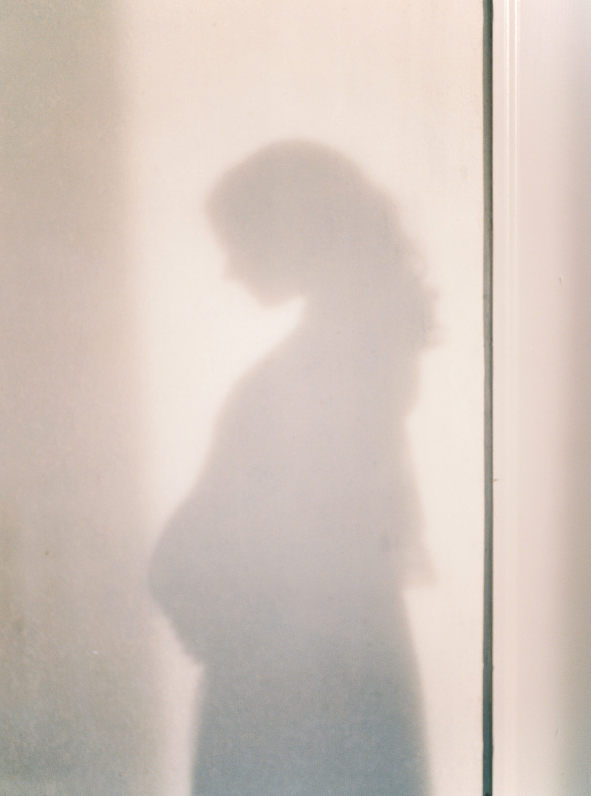 Shadow of an expecting mother.