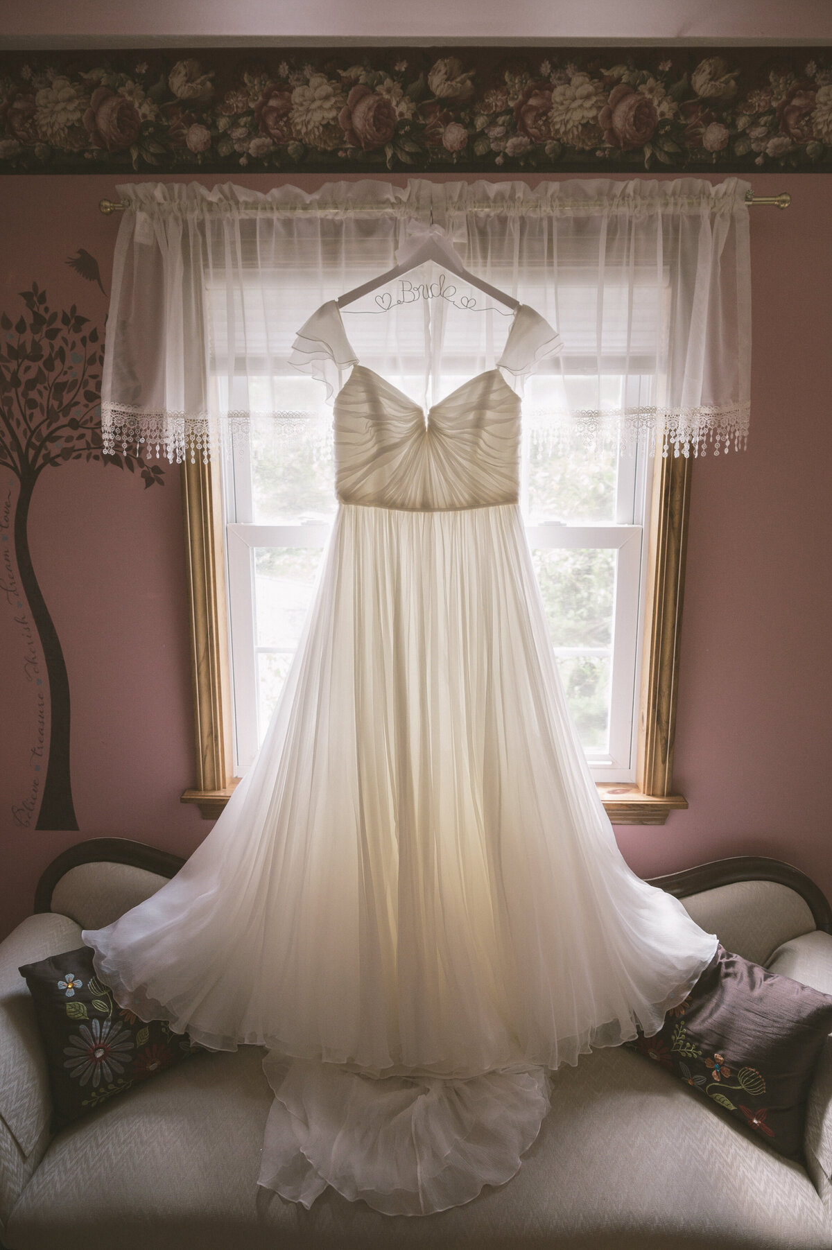 Wedding dress detail by window.