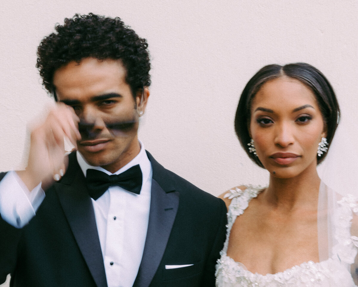 A groom taking off his sunglasses with slow shutter speed.