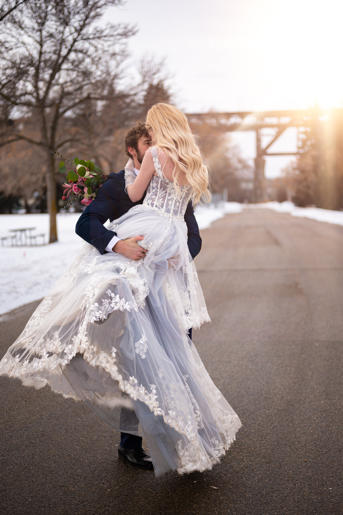 groom spinning bride around at Kinsmen park in Edmonton, Alberta