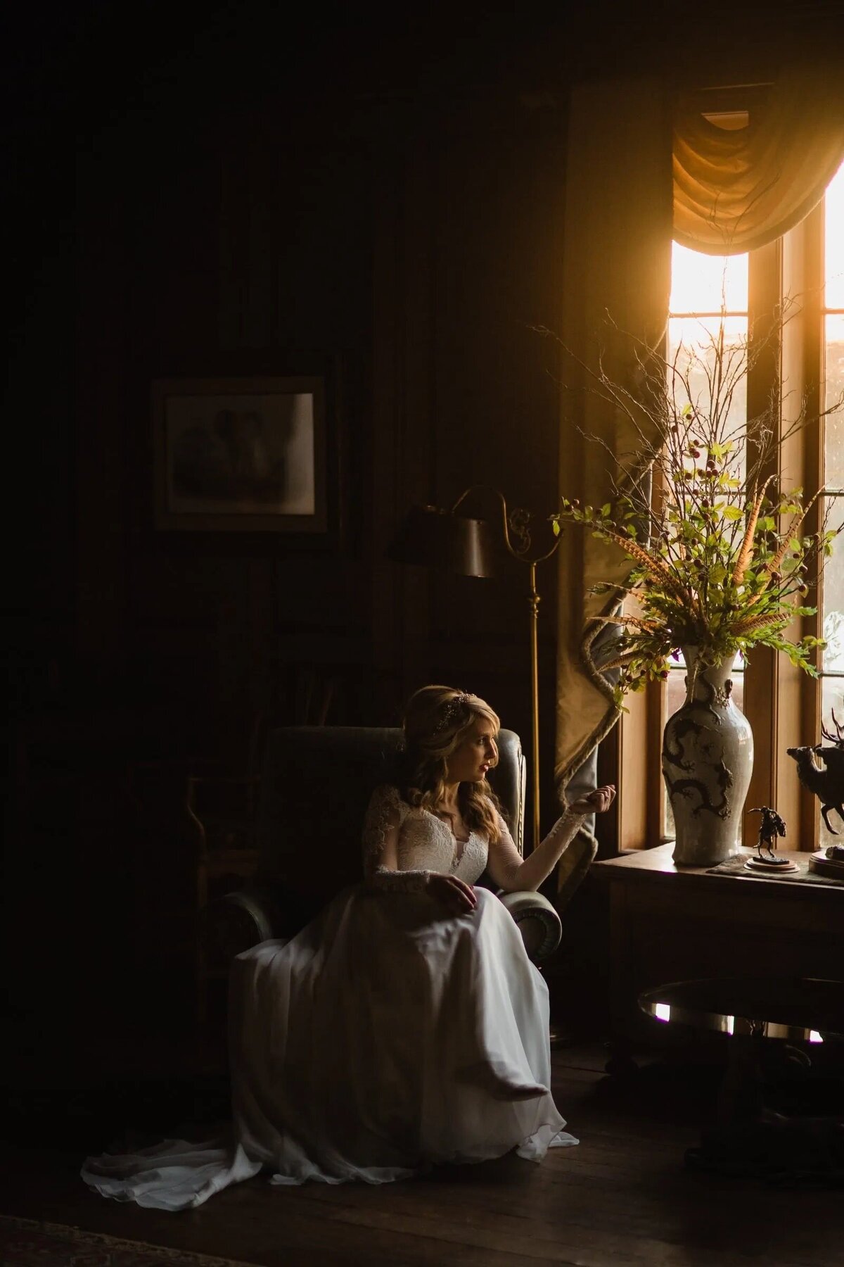A bride sitting in a chair looking out a window