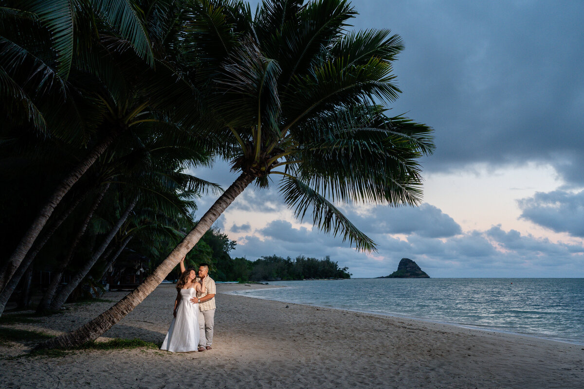 Oahu Hawaii Elopement Adventurous Asian couple at Secret Island Beach during blue hour at night with off camera flash.