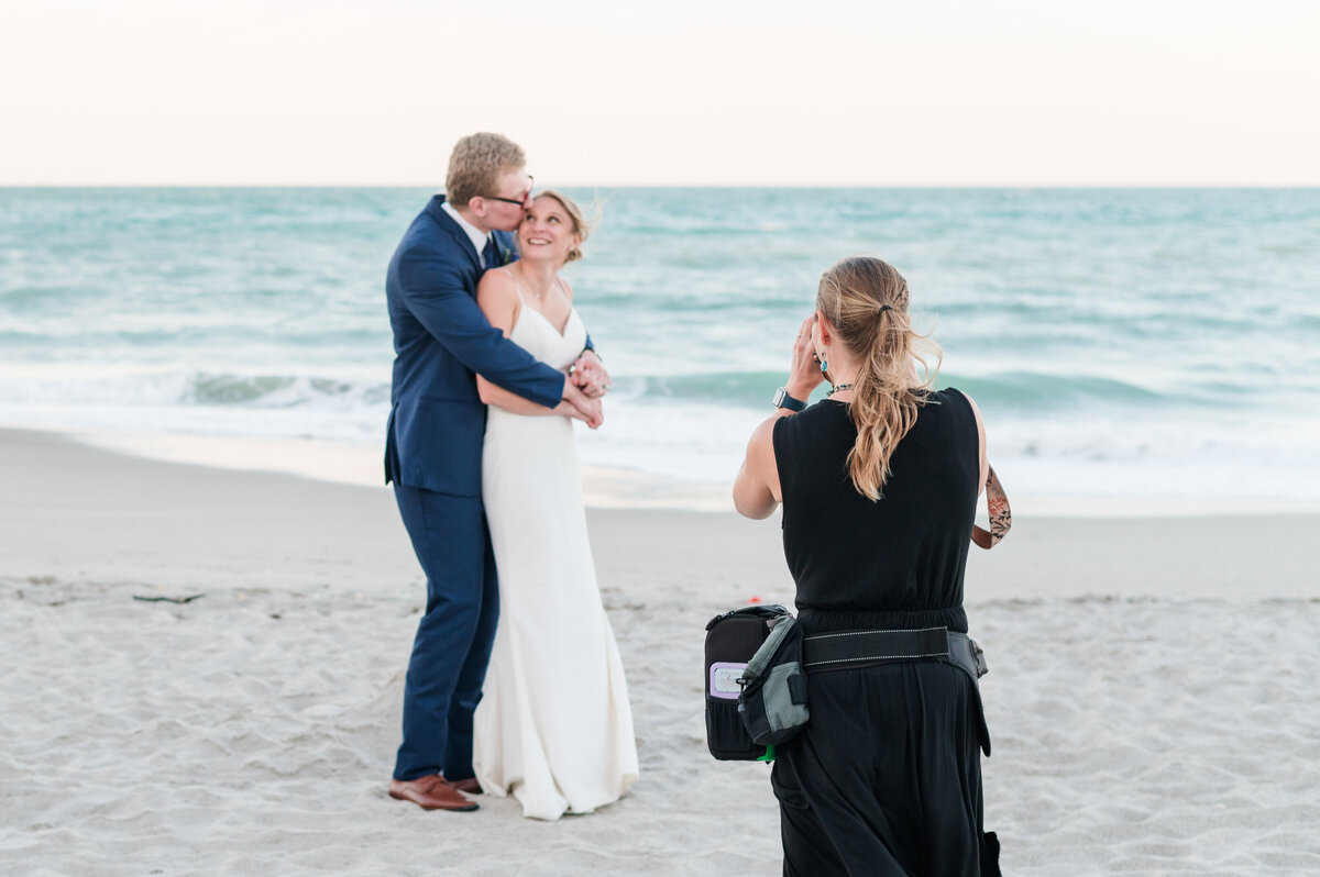 Orlando wedding photographer photographs bride and groom on the beach beside the ocean on their bit day