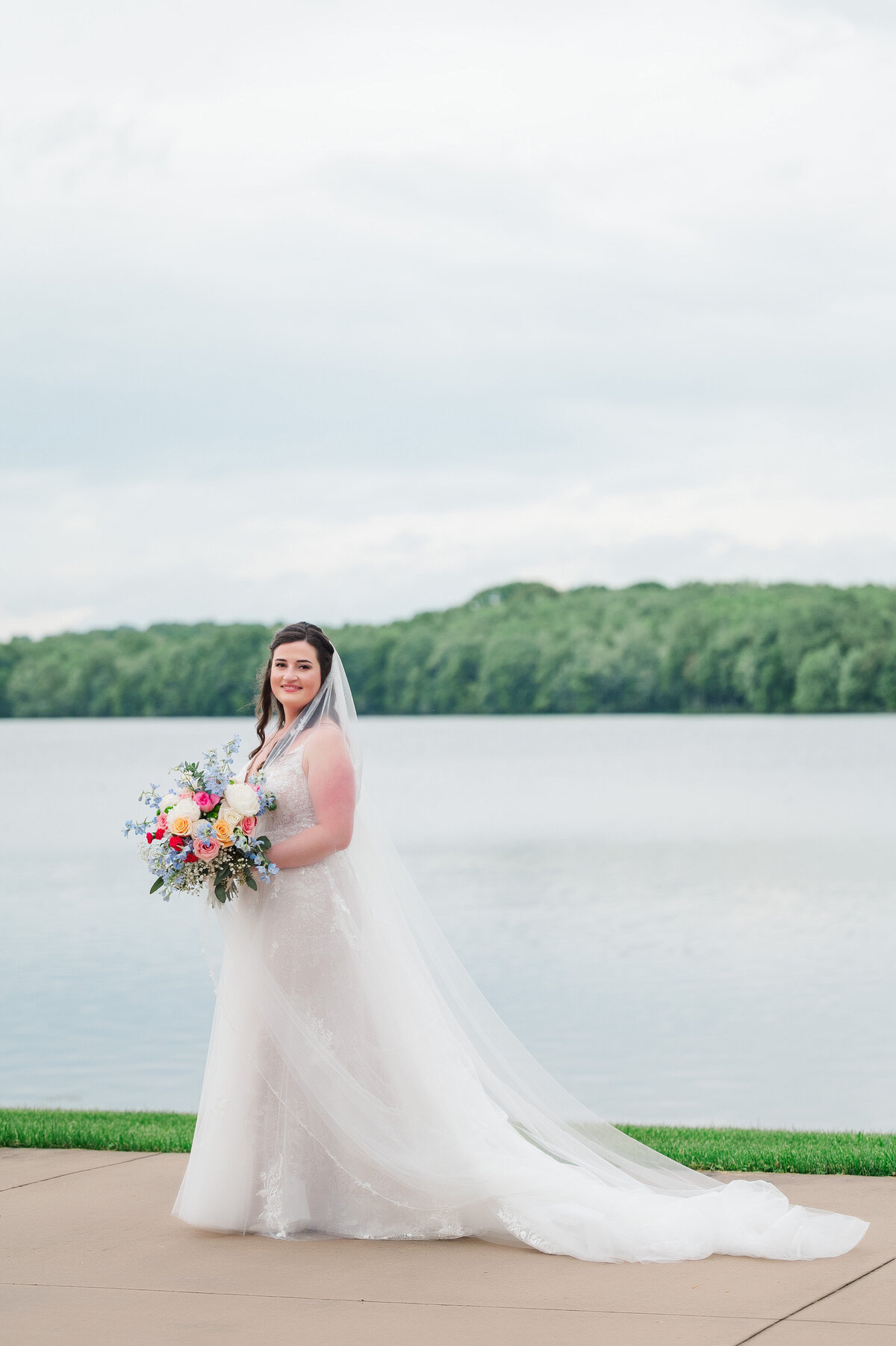 bride walking for wedding picture in front of pine lake in columbiana ohio