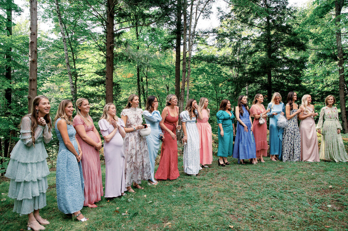 adirondack-mountain-wedding-13-bridal-party-lined-up-in-multicolored-dresses,-styled-by-jove-meyer,-with-mountain-scenery-at-adirondack-mountain-wedding-jenny-fu-studio