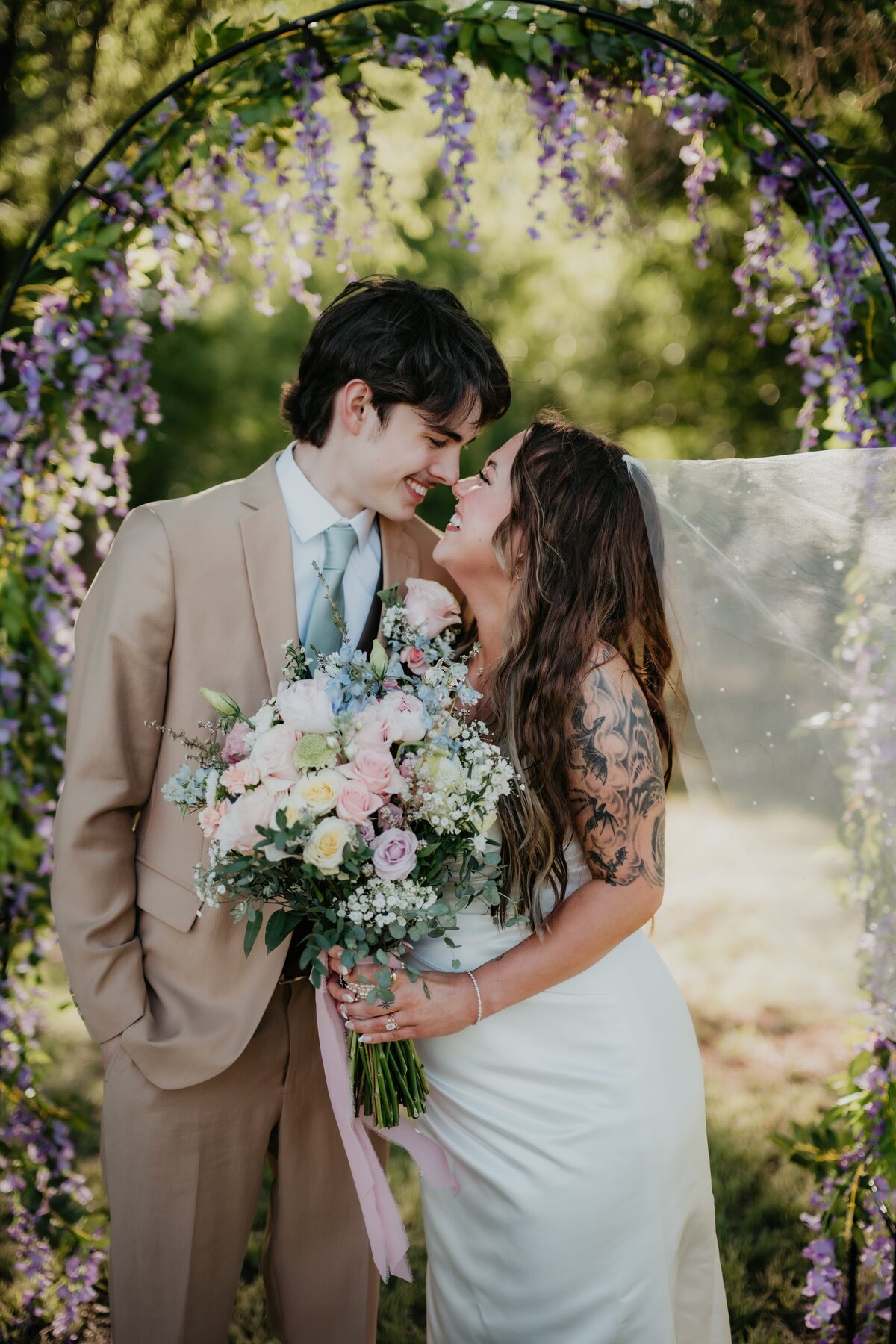 bride and groom standing under arch at wedding, wedding photography in amarillo texas, , Emily wheeler photography