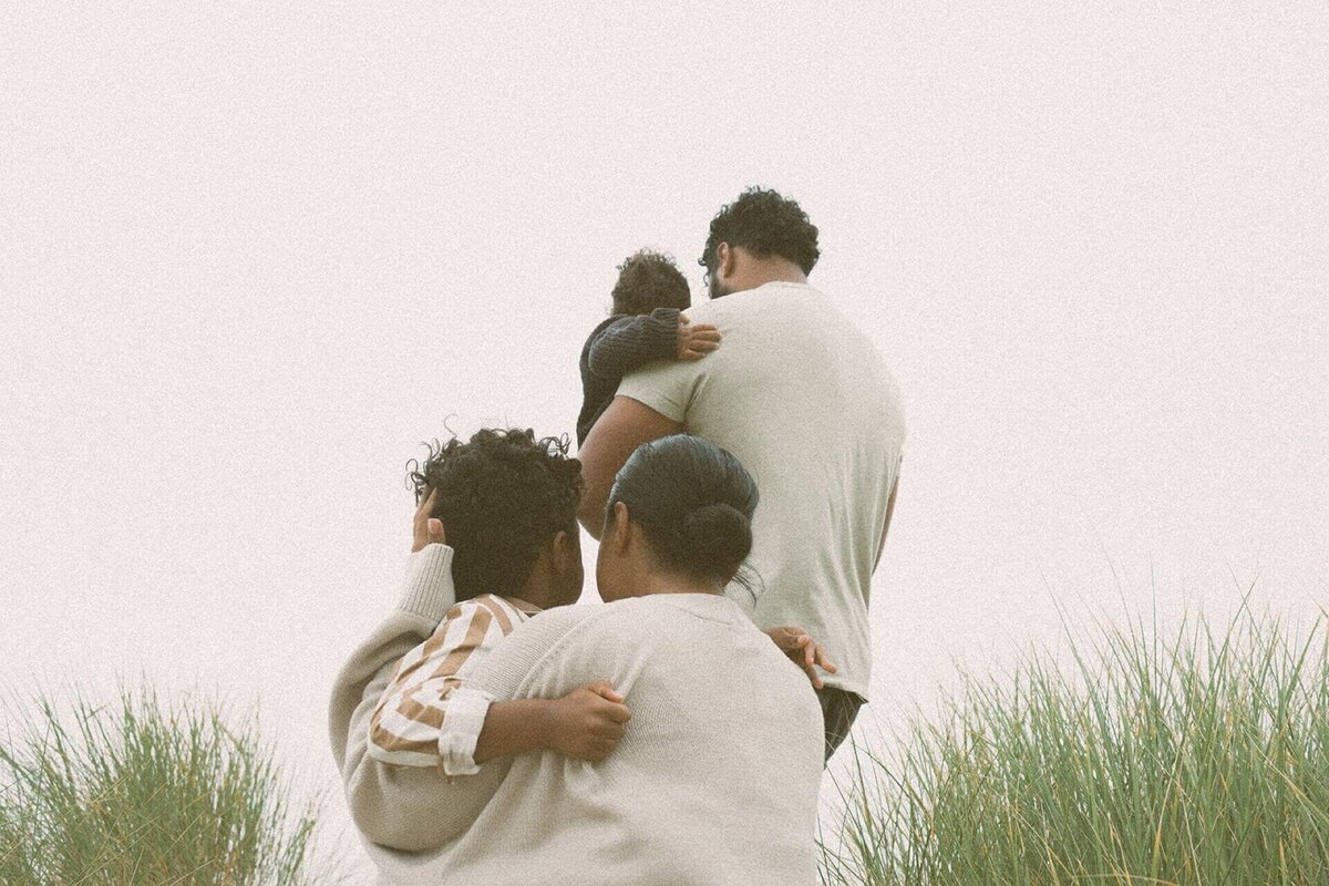 family of four on beach bluff with two small children