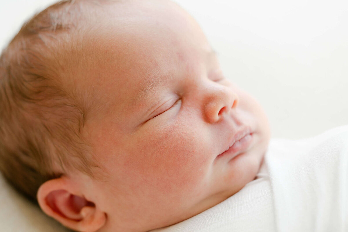Baby wrapped in neutral swaddle, captured by San Francisco Bay Area newborn photographer.