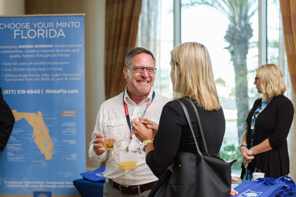 Attendees laugh as they talk to each other