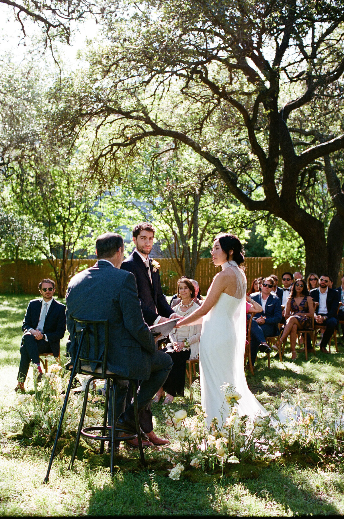 Bride and groom exchanging vows at outdoor wedding ceremony at Mattie's Austin