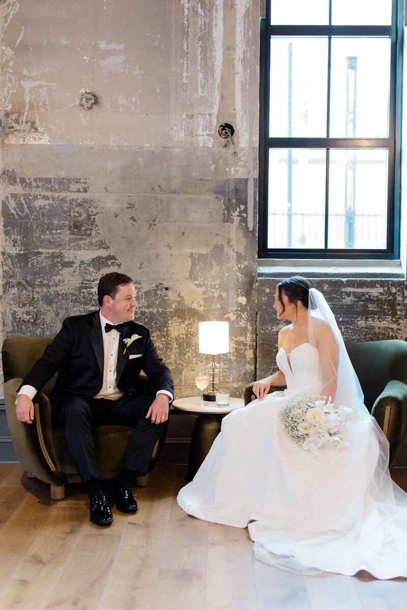 bride and groom sitting in lounge at the switch house in philadelphia