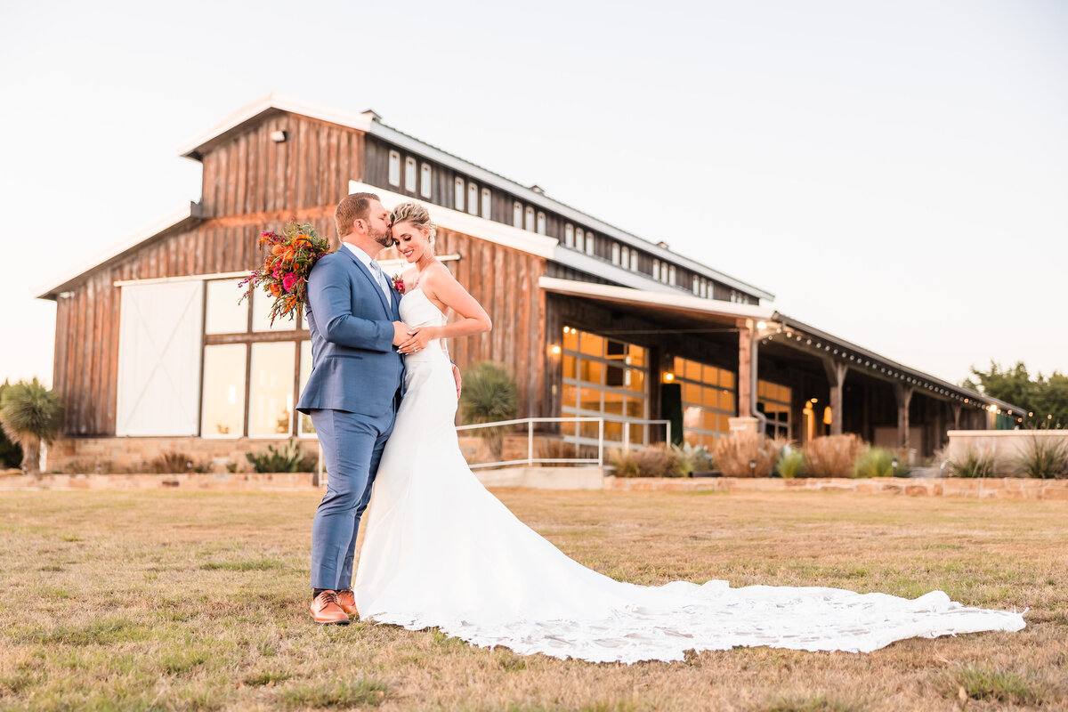 Bride & Groom embrace at the Camp Retreat wedding venue in Fredericksburg, Texas.