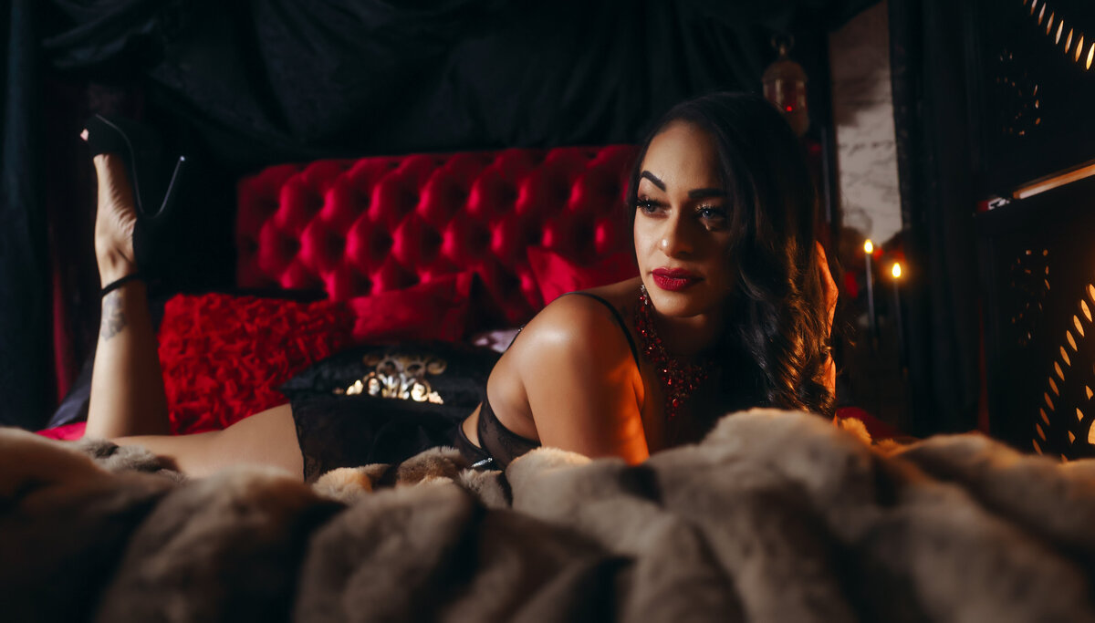 Savannah boudoir brunette on red bed