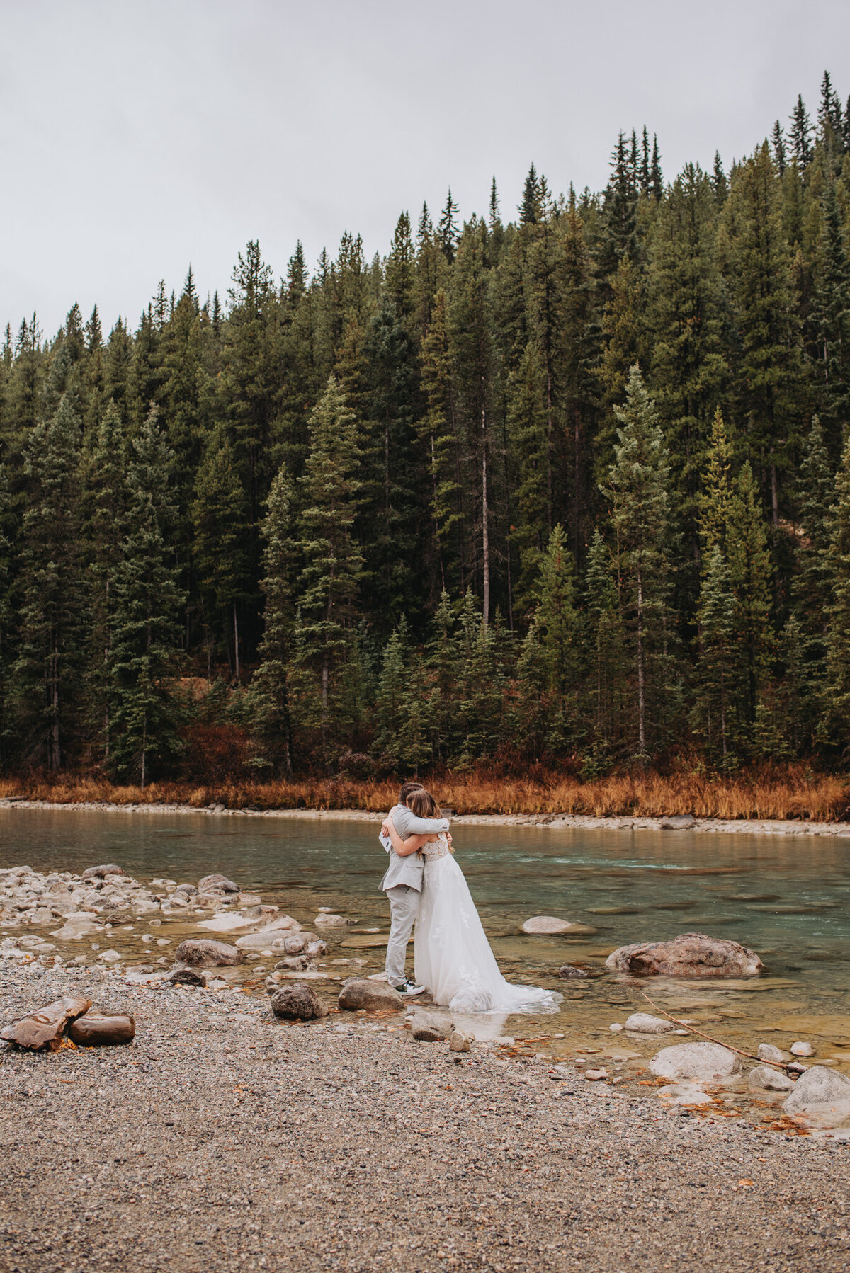 A couple leans in for a hug in Banff National Park on their elopement day