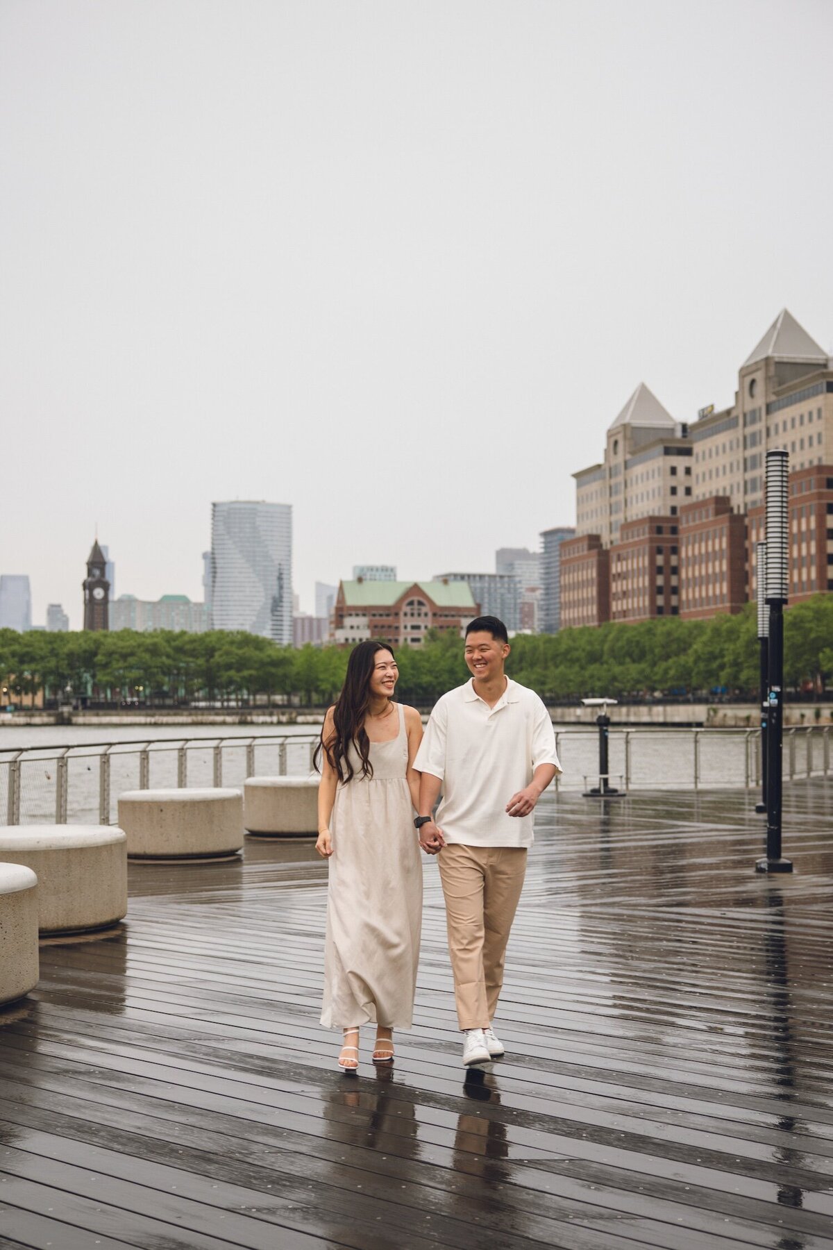 Couple embracing on a Hoboken pier with NYC skyline in background