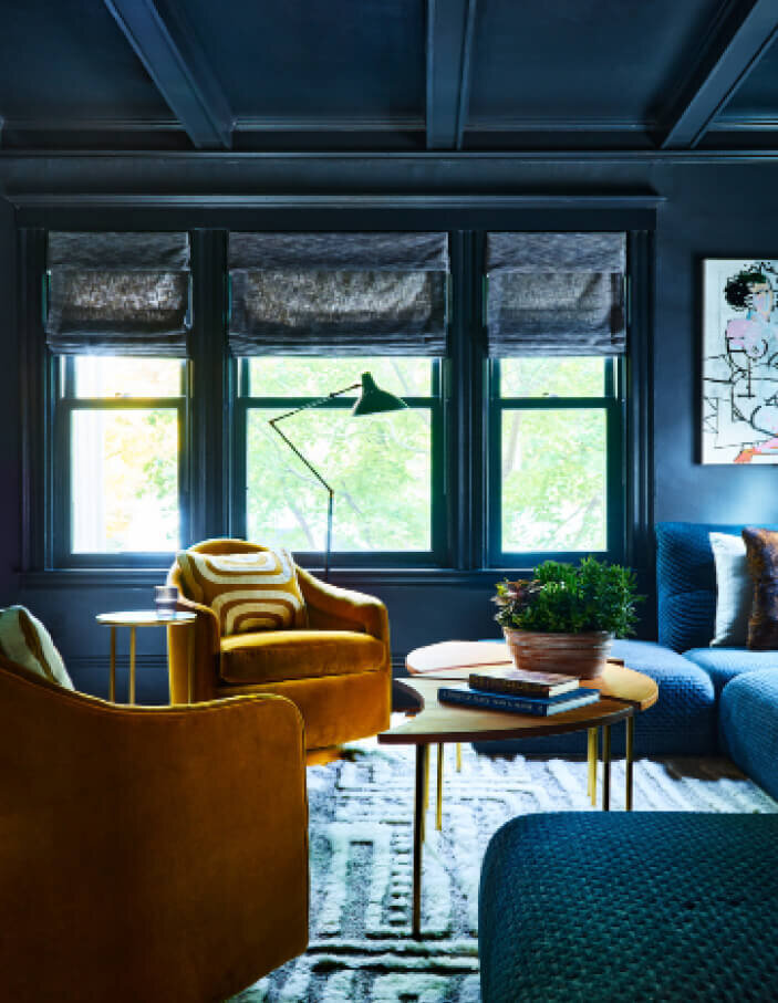 Boston area design firms mixed modern furniture with vintage pieces in a historic renovation project, blending contemporary style with classic architecture.
