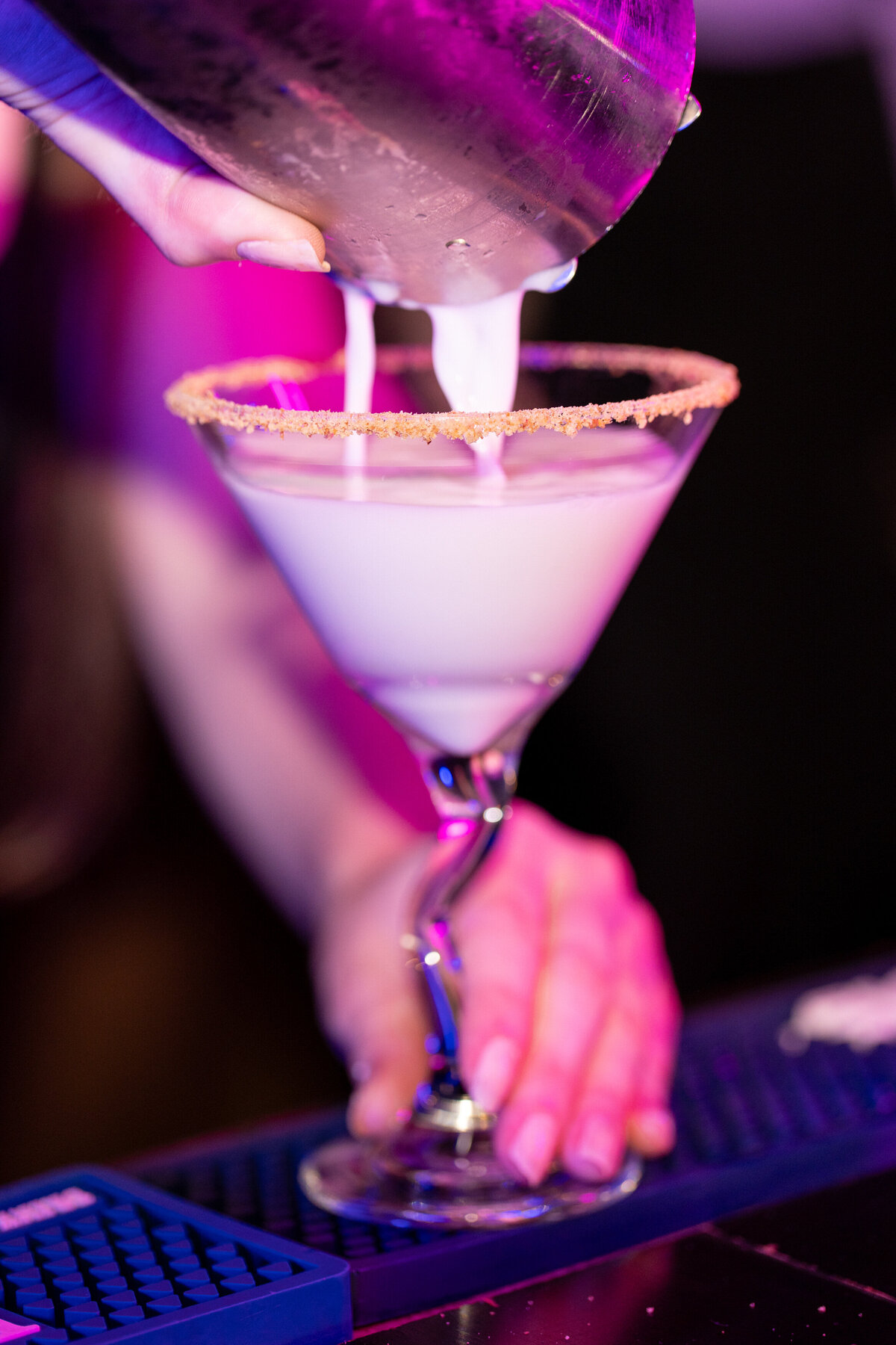 An espresso martini being poured into a glass 
