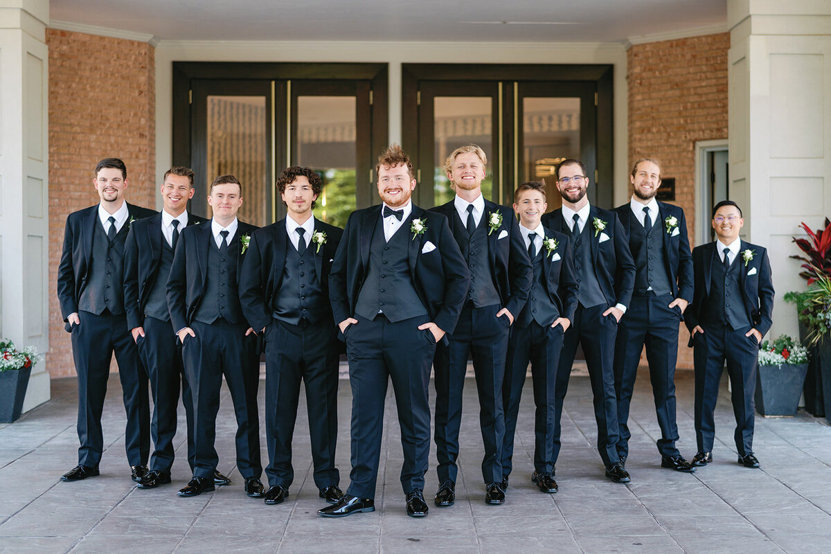 Groom and groomsmen wearing black suits