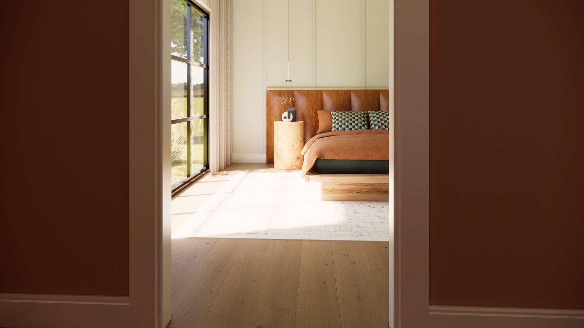 Looking through a door into a light filled bedroom.