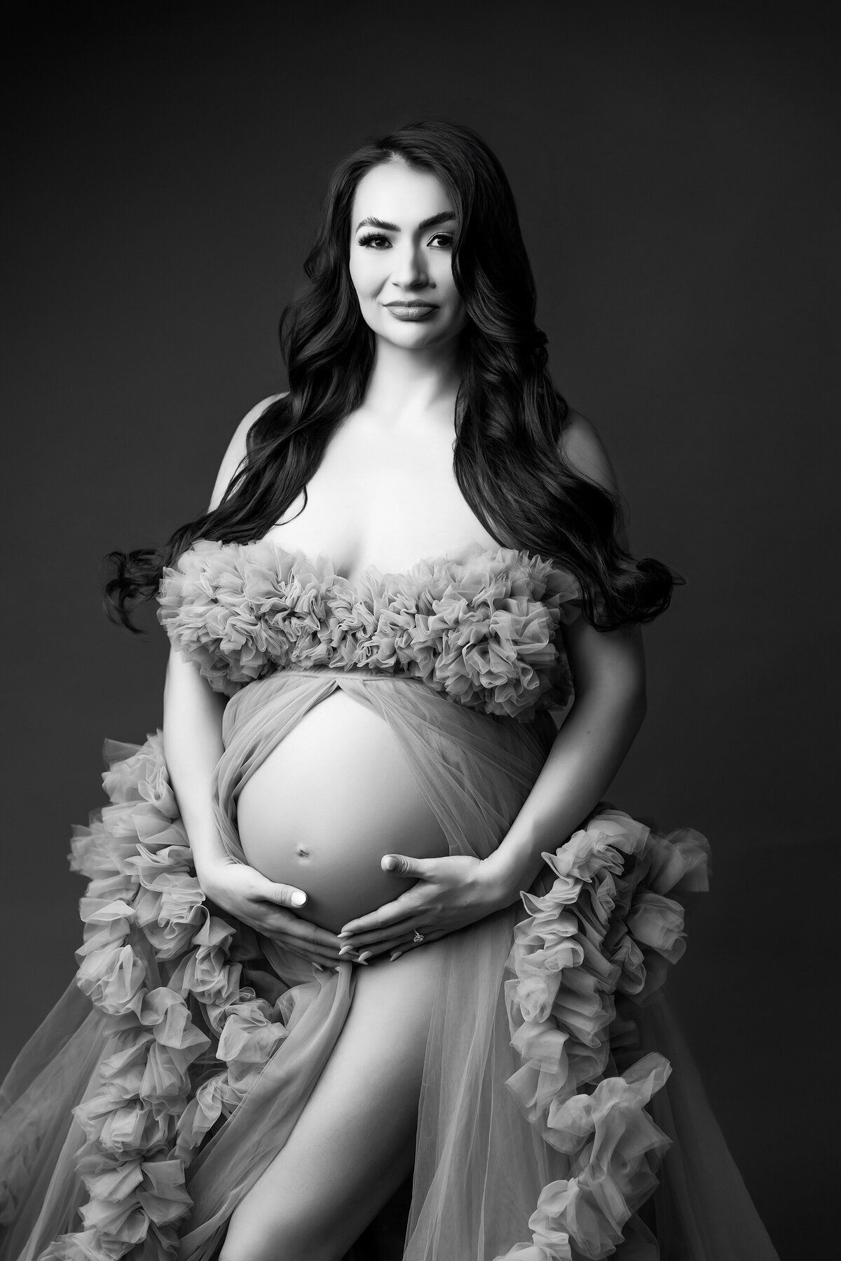 pregnant woman posing in tulle gown for phoenix maternity session