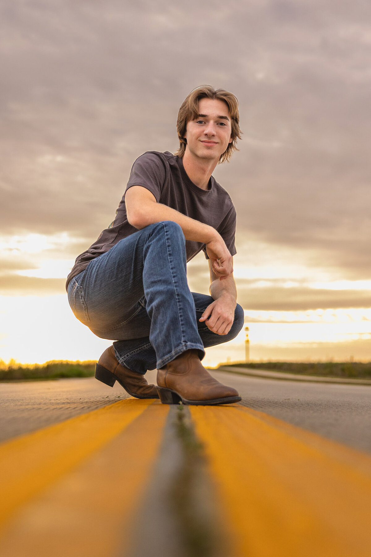 A senior guy squatting in the middle of the road in Lawrence, KS