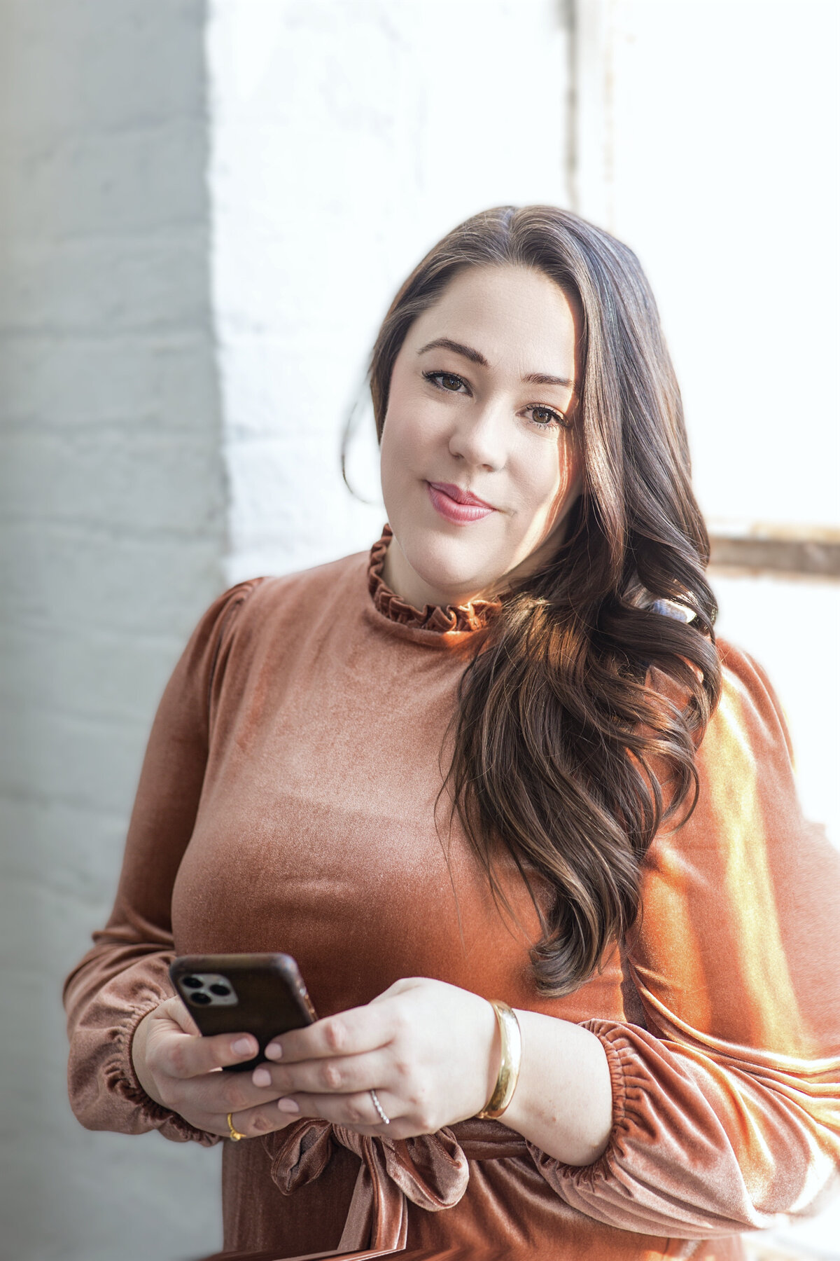 Girlholding phone by window