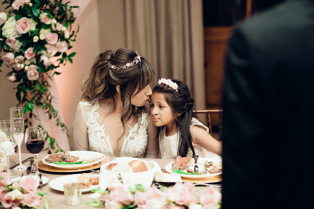 Wedding Photograph Of Bride Kissing a Child's Forehead Los Angeles
