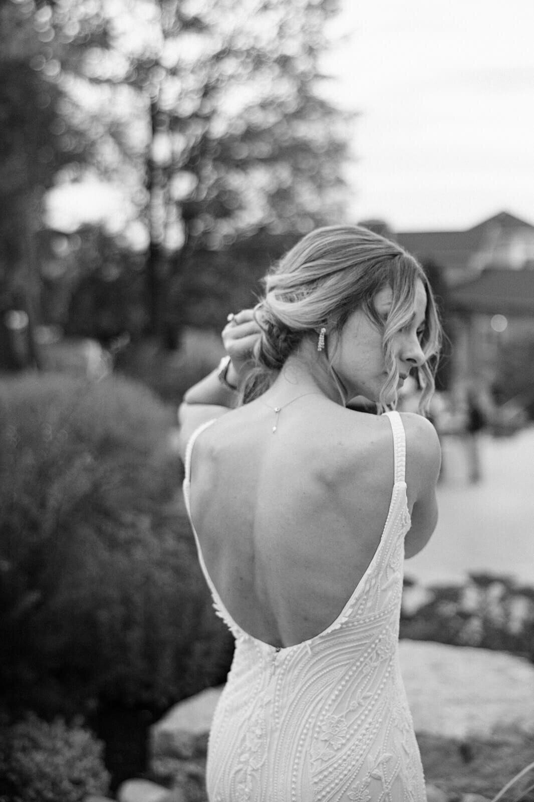 Bride fixing hair at Finger Lakes Wedding, New York