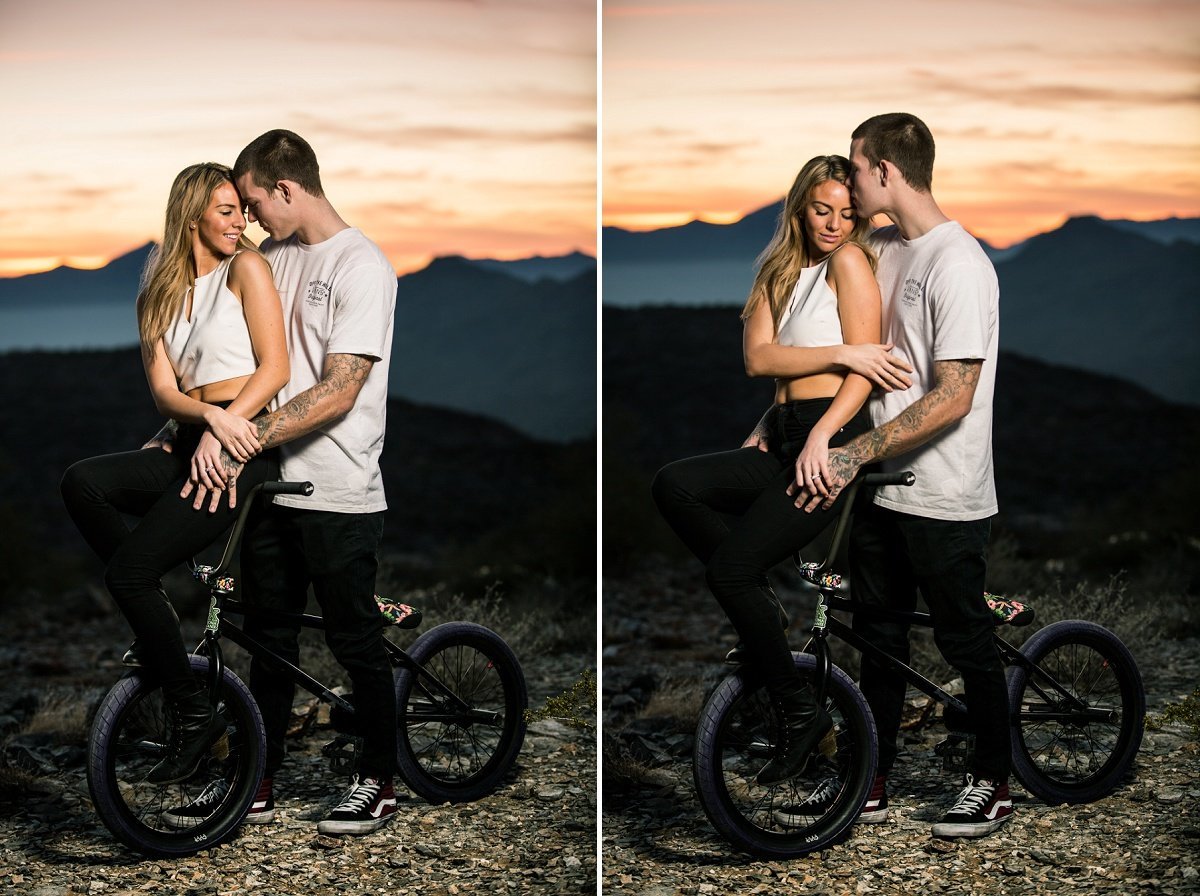 Engaged couple pose for romantic engagement photos during sunset on a bike trail