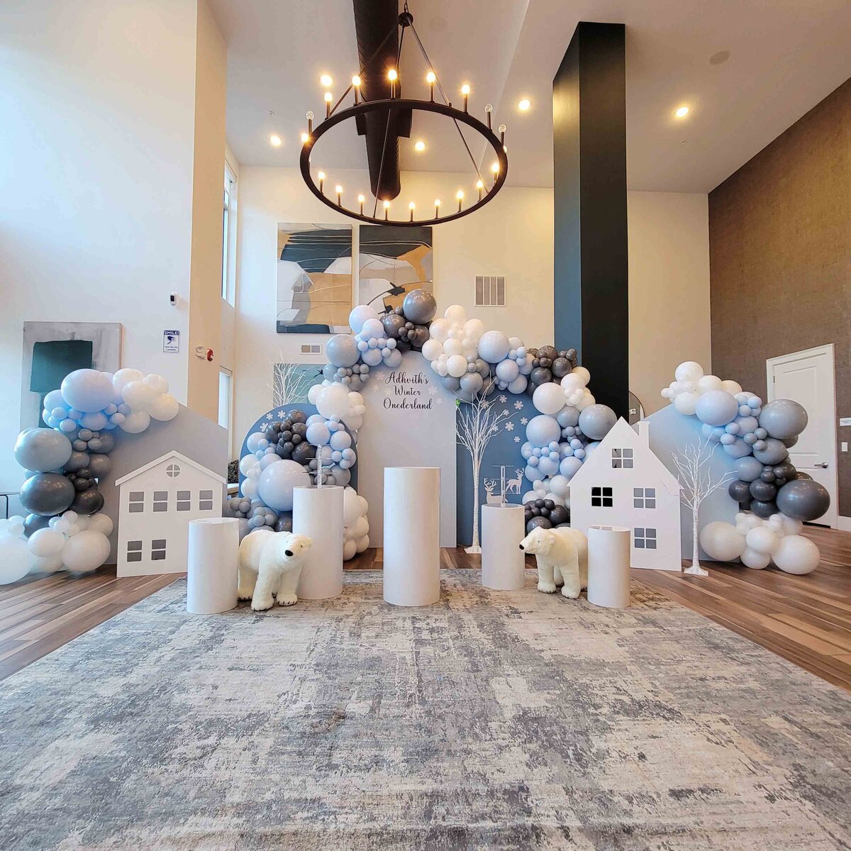 Boy's celebration into a winter wonderland with Air with Flair Decor's Custom Balloon Installation, featuring a Polar Bear Party theme.