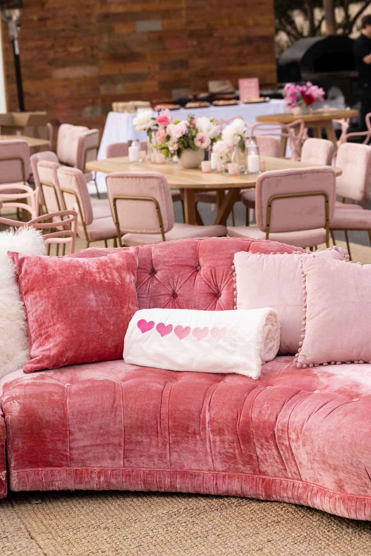 Pink sofa with a folded blanket with pink hearts