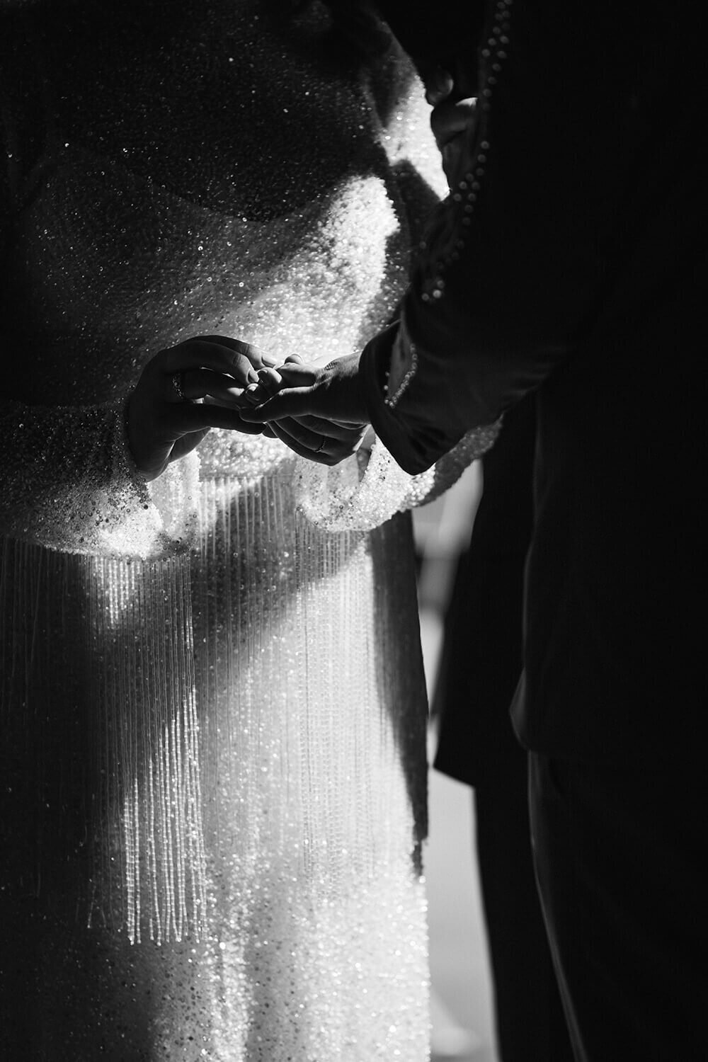 a bride and groom exchanging rings during their wedding ceremony in taranaki