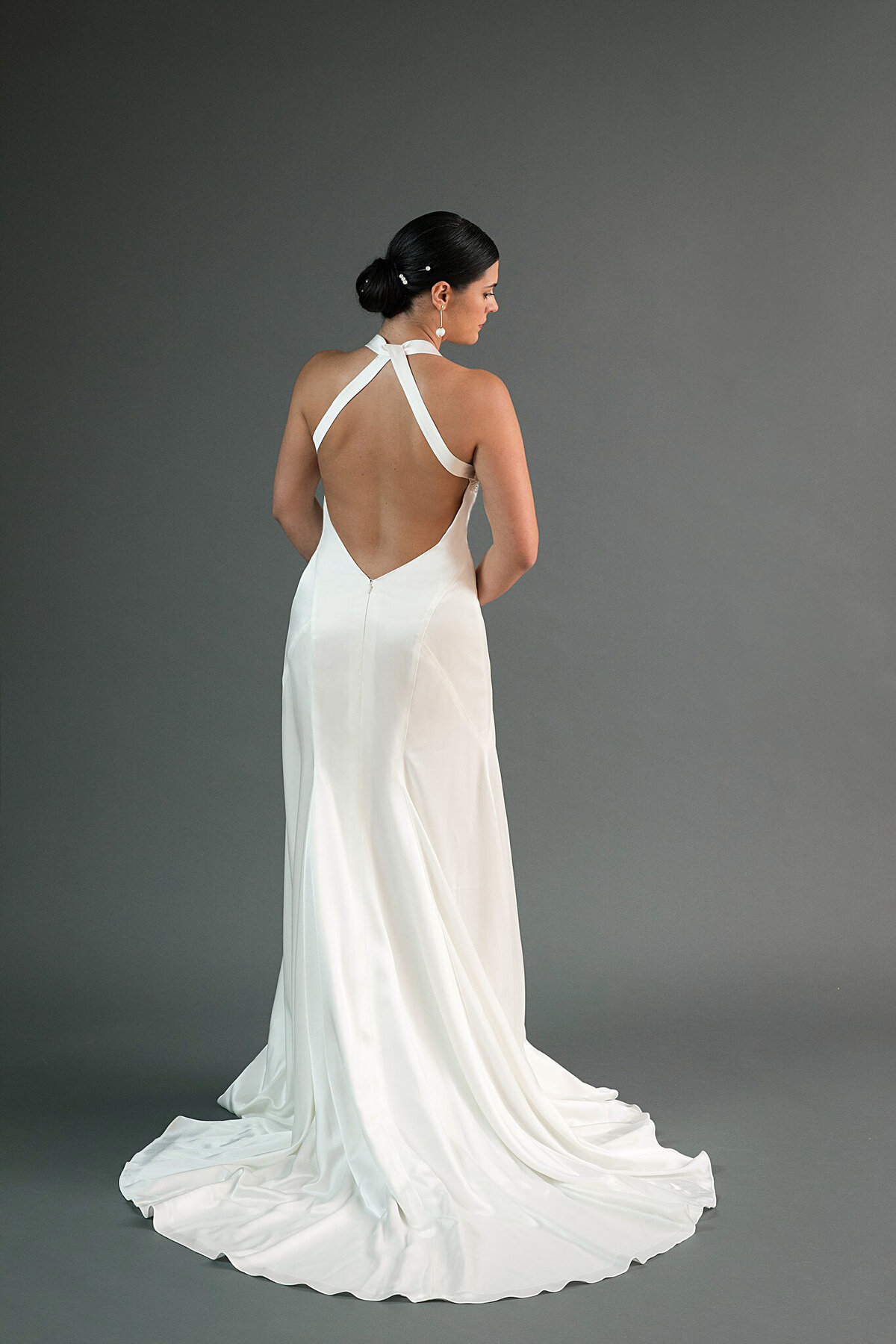 The low open back of the Yuri wedding dress style also features intricate seaming on the back of the hips drawing your eyes down to the charmeuse train.