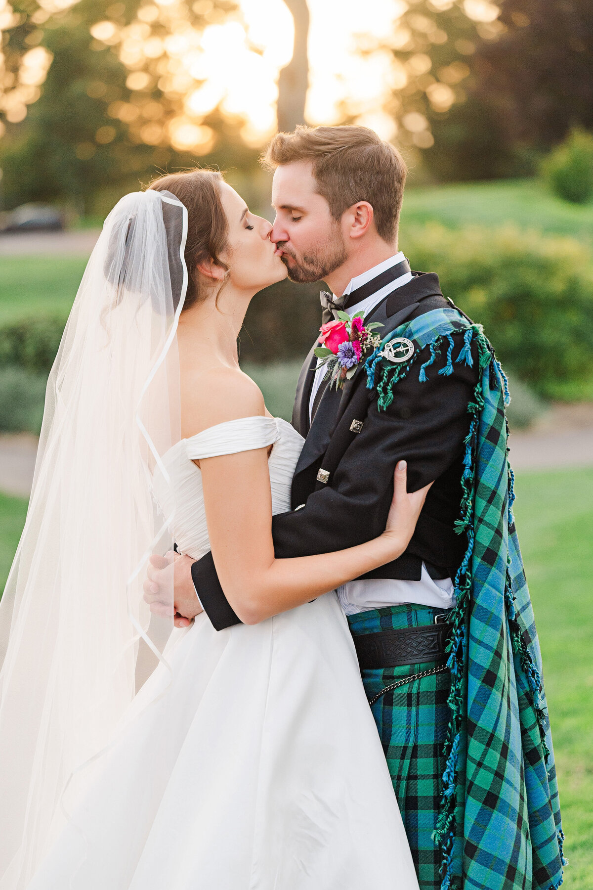 bride and groom kissing at lake club of ohio golf course