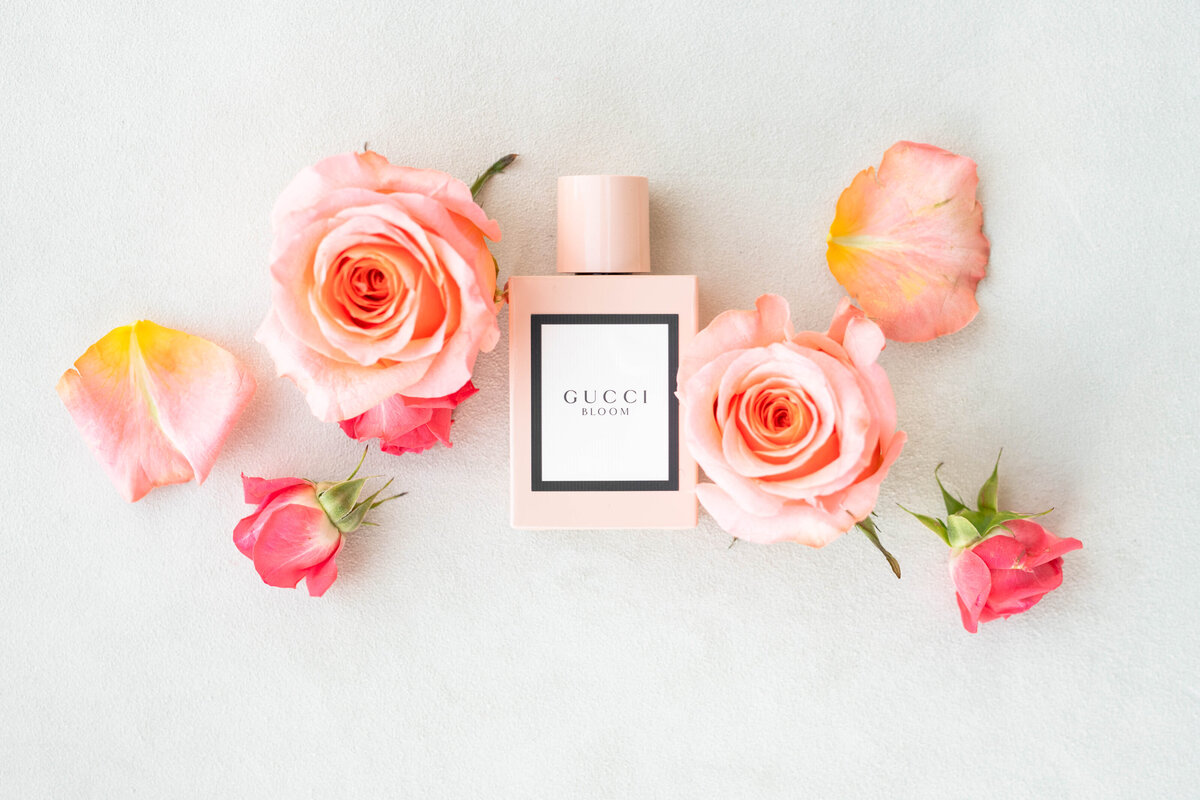 Flatlay image of Gucci Bloom perfume and floral cuttings