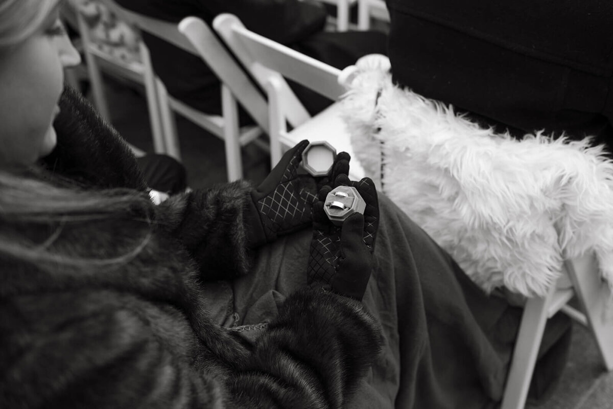 Ring bearer gently gazes upon the wedding rings that lay delicately inside of a velvet box at the St. Regis Aspen wedding.