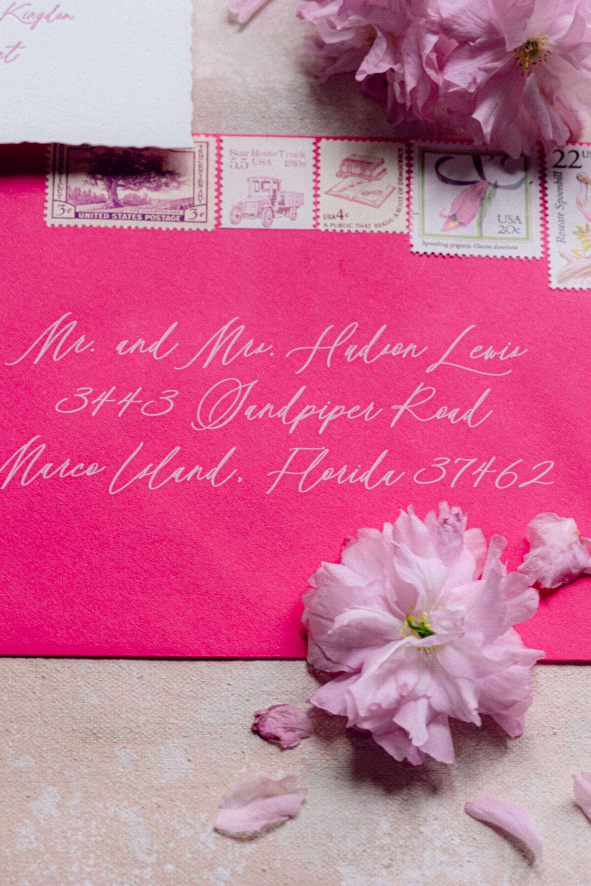 A wedding photo of the brides pink wedding invitations