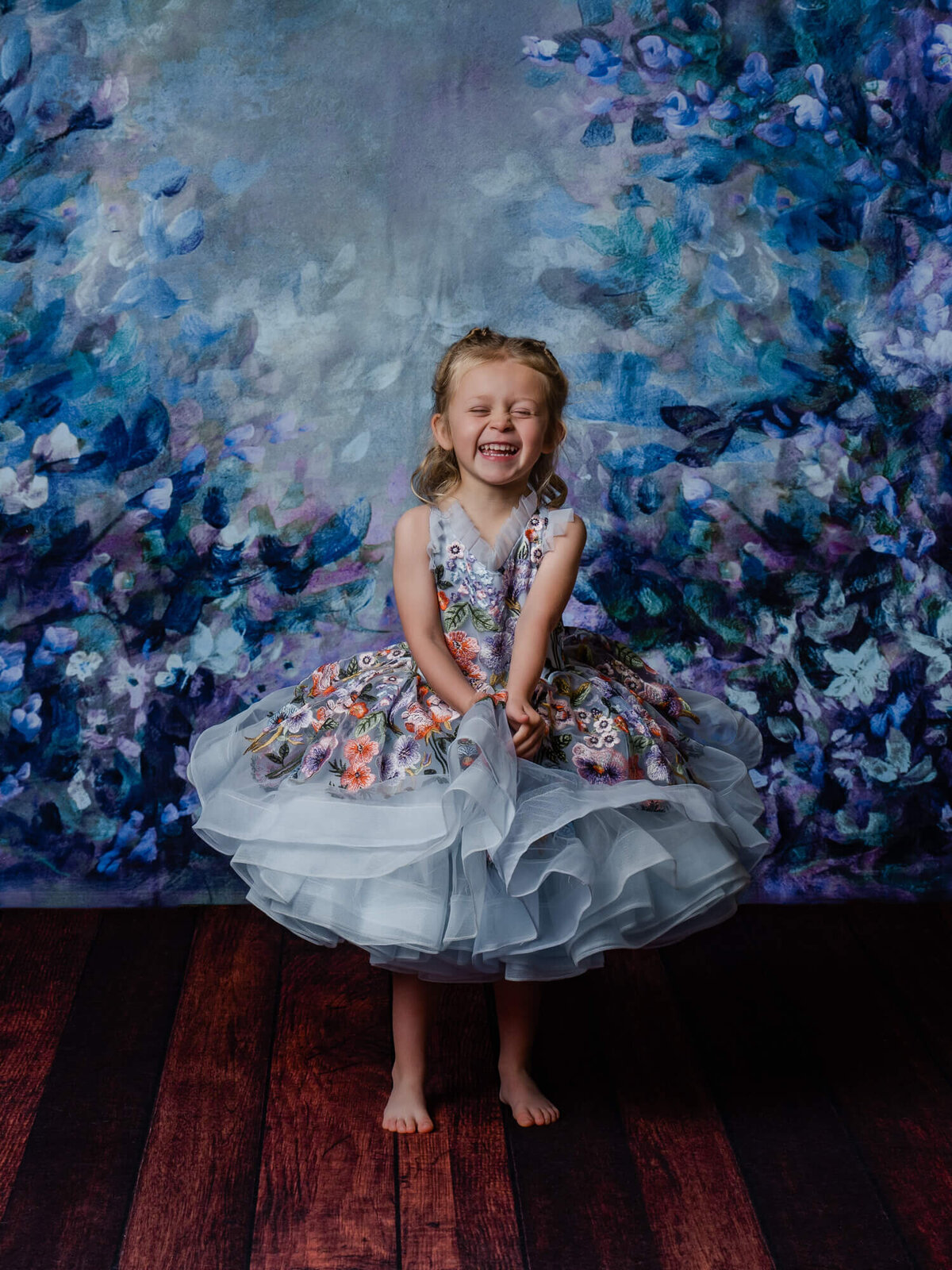 Little girl giggles and smiles in dream dress session  in Prescott kids photography session by Melissa Byrne