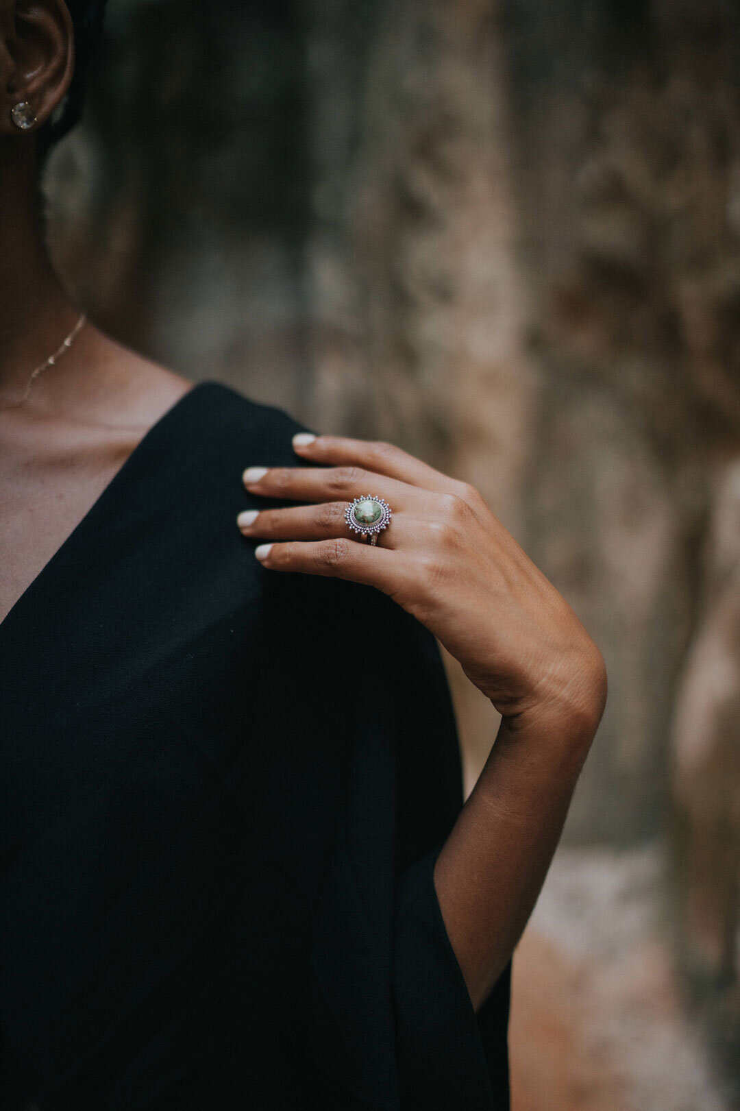 Woman wearing diamond engagement ring and black dress