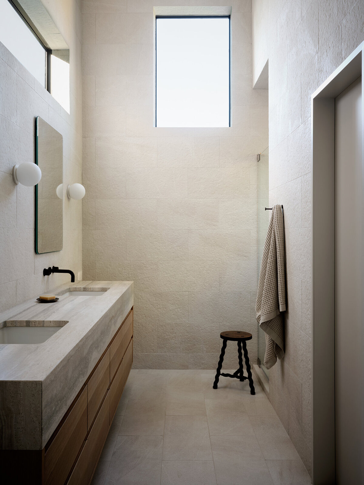 minimal-timeless-bathroom-spa-textured-tile-travertine-countertop-oak-vanity-warm-natural-light-wood-austin-interior-design-house-franc