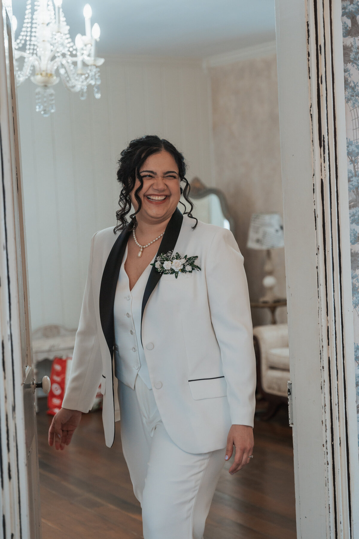 Smiling bride stands in the doorway of a Tennessee home 