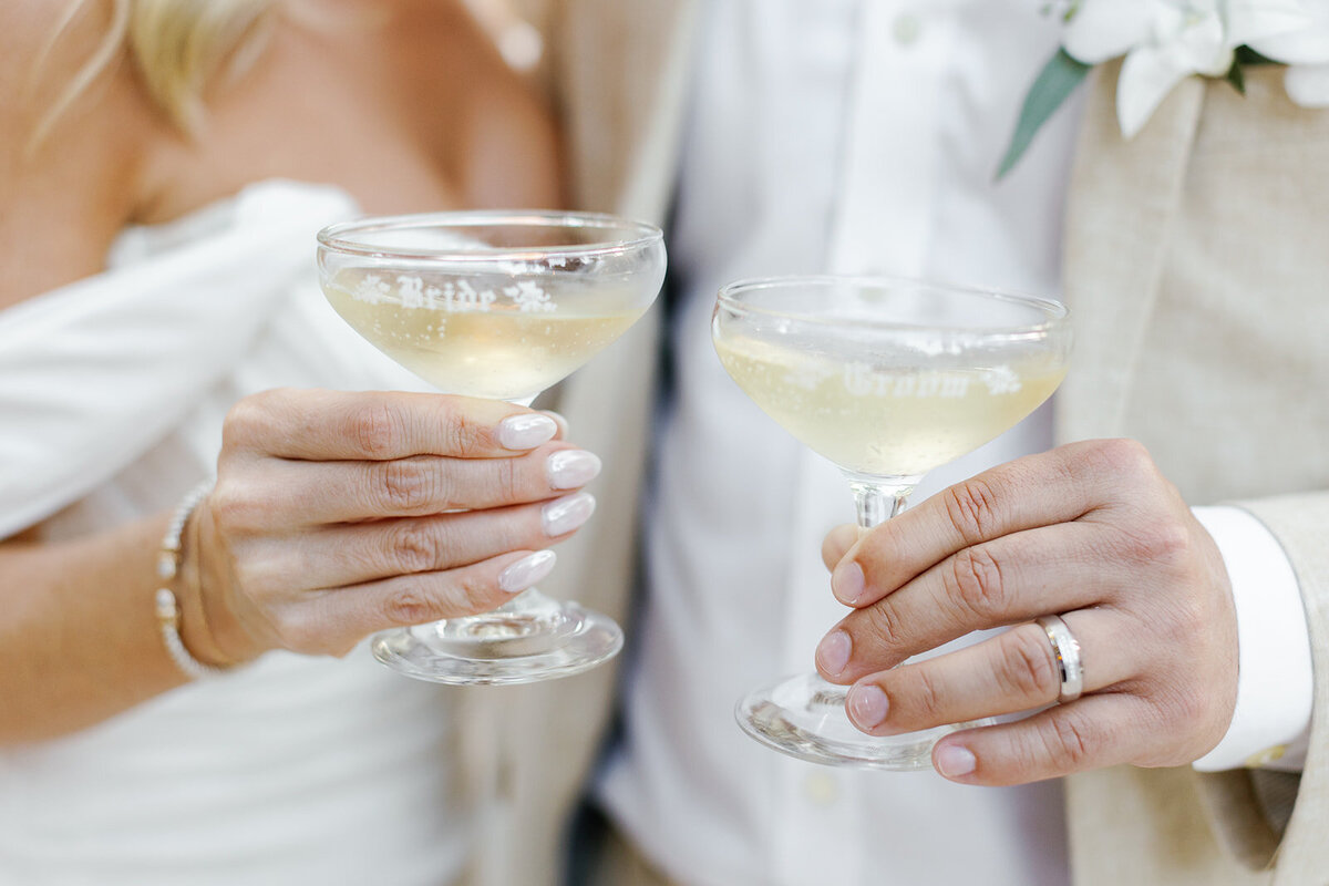 The couple clinks champagne glasses, marking the start of their new journey as husband and wife at their destination wedding.
