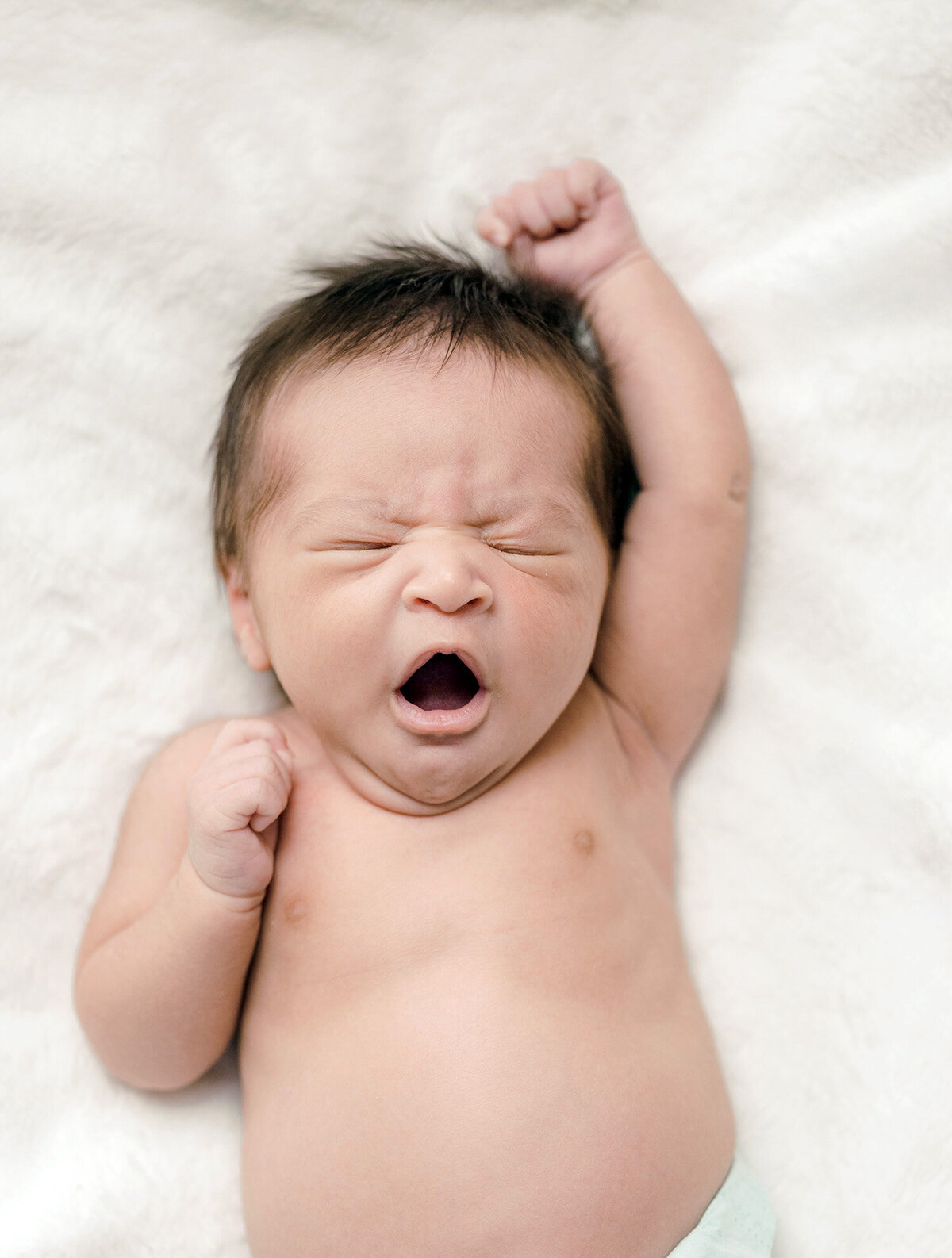 San Francisco natural newborn photographer capturing baby yawning during relaxed photo session